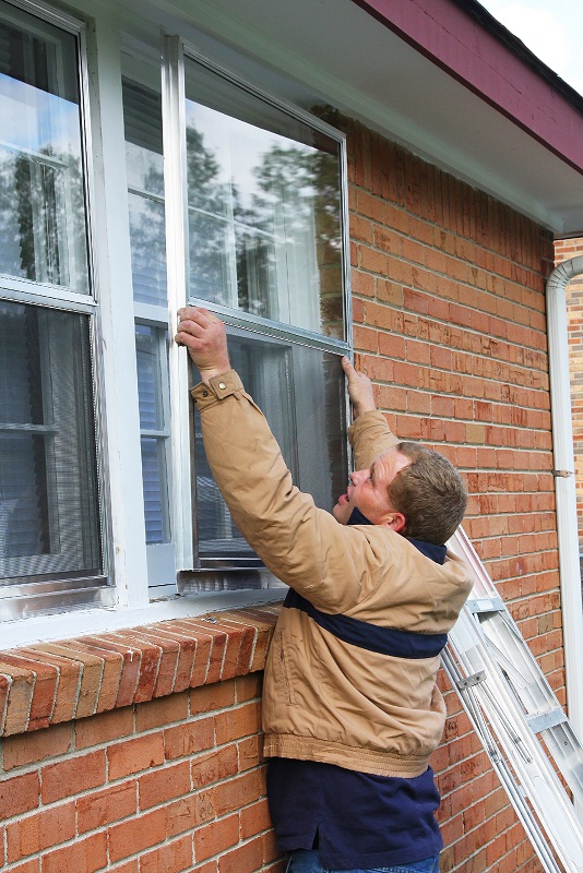 storm windows being installed